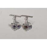 A pair of sterling silver cufflinks in the form of owls