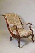 A Victorian rosewood show frame open arm easy chair, with scrolled back and shaped arms, raised on