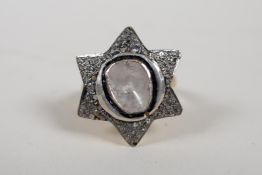 A silver gilt ring in the form of St David's star, set with a large uncut diamond, size 'P'