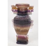 A C19th Chinese striated fluorspar vase with two handles and carved decoration, 8" high