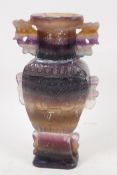 A C19th Chinese striated fluorspar vase with two handles and carved decoration, 8" high