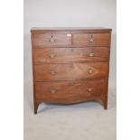 A George III mahogany chest of two over three drawers, with reeded edge top and brass plate handles,