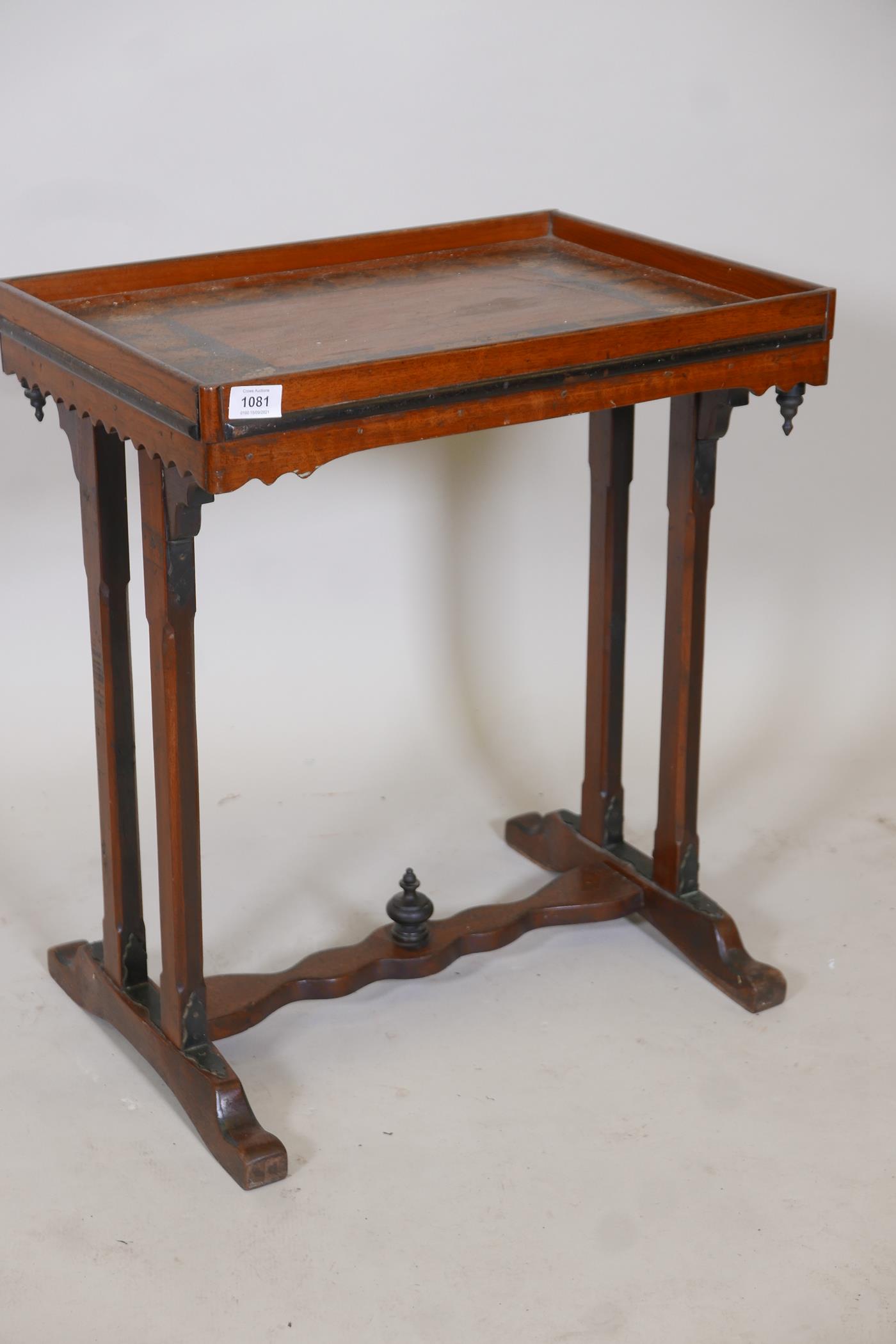 A C19th mahogany side table, with painted and parcel gilt top and shaped frieze, raised on end