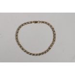 A yellow gold and diamond set link bracelet, probably 10ct, 6½" long