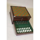 A mahogany three drawer chess and backgammon board, with a complete set of resin chess pieces, A/