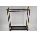 A C19th brass rail stick stand on cast iron base, 22½" high, 18" wide