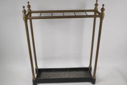 A C19th brass rail stick stand on cast iron base, 22½" high, 18" wide