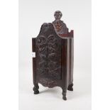 A C19th French carved wood candle box in the form of an armoire, with sliding door, 14" high