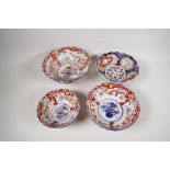 Four C19th Imari porcelain bowls decorated with traditional patterns, largest 10" diameter