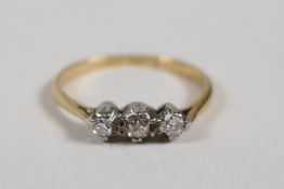 An 18ct yellow gold ring set with three brilliant cut diamonds, size L