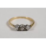 An 18ct yellow gold ring set with three brilliant cut diamonds, size L