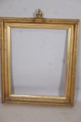 A C19th gilt picture frame with crown and cushion finial, aperture 27" x 33"