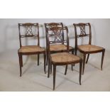 A set of four Sheraton style chairs with pierced backs and Adam style carved decoration, raised on