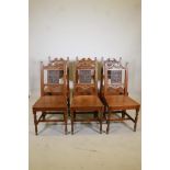 A set of six oak dining chairs with carved backs