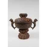 A cast iron censer with two dragon shaped handles, and a pierced cover, Chinese, 9" high