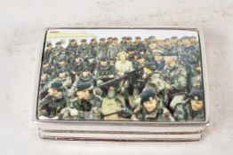 A sterling silver pill box, the cover decorated with a military scene, 2" long
