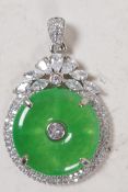 A silver mounted jade and white stone pendant, 1" diameter