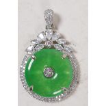 A silver mounted jade and white stone pendant, 1" diameter