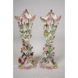 A pair of C19th flower encrusted spill vases, A/F, 10" high