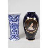 A Vienna porcelain vase with decorative panels  on a deep blue ground, 9½", and a Delft blue and