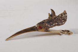 A brass money clip in the form of a birds head, 5" long