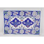 An Iznik tiled panel, 25" x 17"