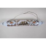 A Victorian milk glass rolling pin, painted with flowers and a three masted ship, 14" long