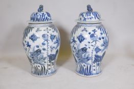 A pair of Chinese blue and white porcelain meiping jar and covers decorated with carp in a lotus