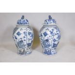 A pair of Chinese blue and white porcelain meiping jar and covers decorated with carp in a lotus