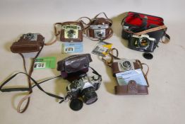 A collection of vintage SLR 35mm cameras, Canon AE-1 Asahi Pentax Spotmatic, Kodak Retinette, Ilford