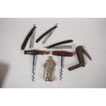 Two antique wood and steel corkscrews, one with brush, 5" long, together with a C19th brass