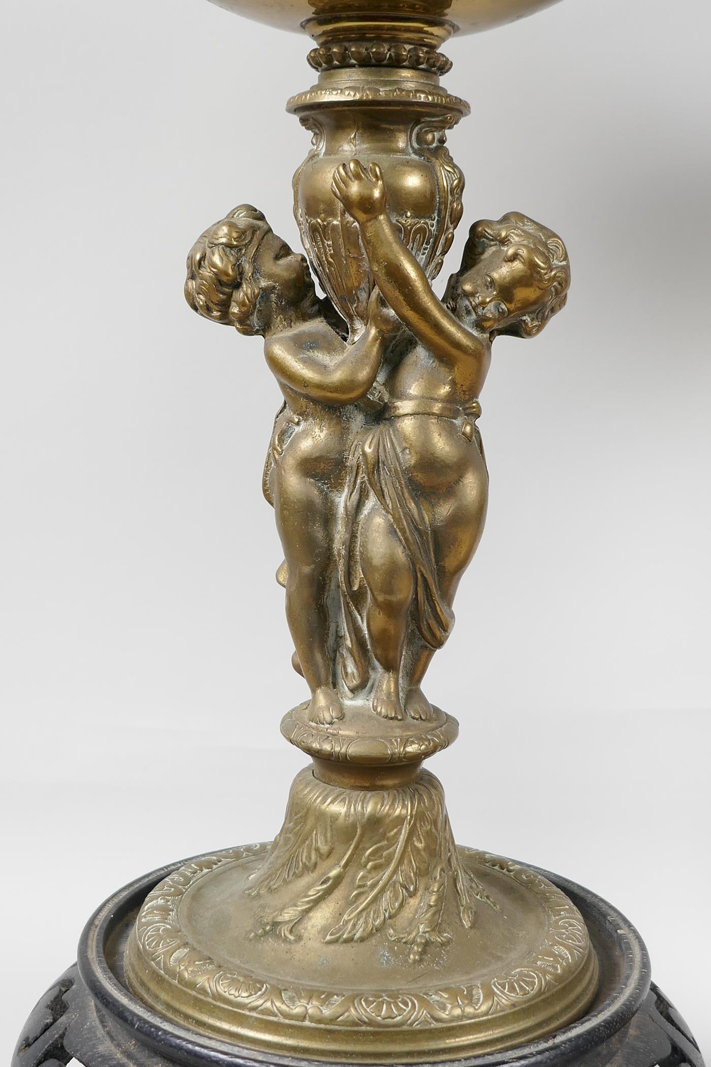 Two table lamps, the central bronze columns cast as two cherubs supporting an urn, with brass oil - Image 4 of 4