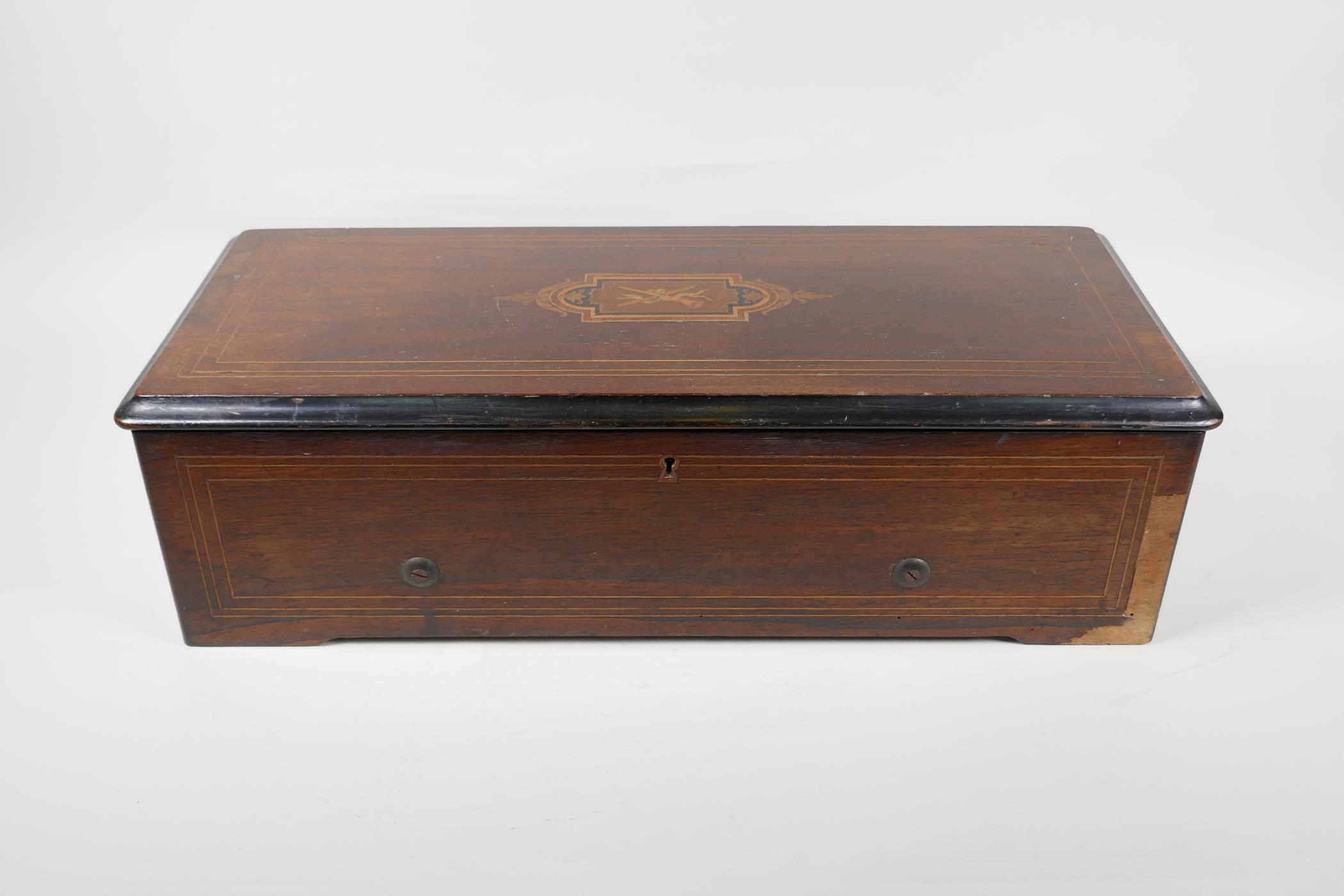 A C19th Swiss rosewood veneered music box with cross banded inlay, playing 6 aires, lacks melody