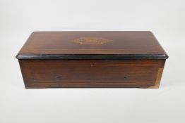 A C19th Swiss rosewood veneered music box with cross banded inlay, playing 6 aires, lacks melody