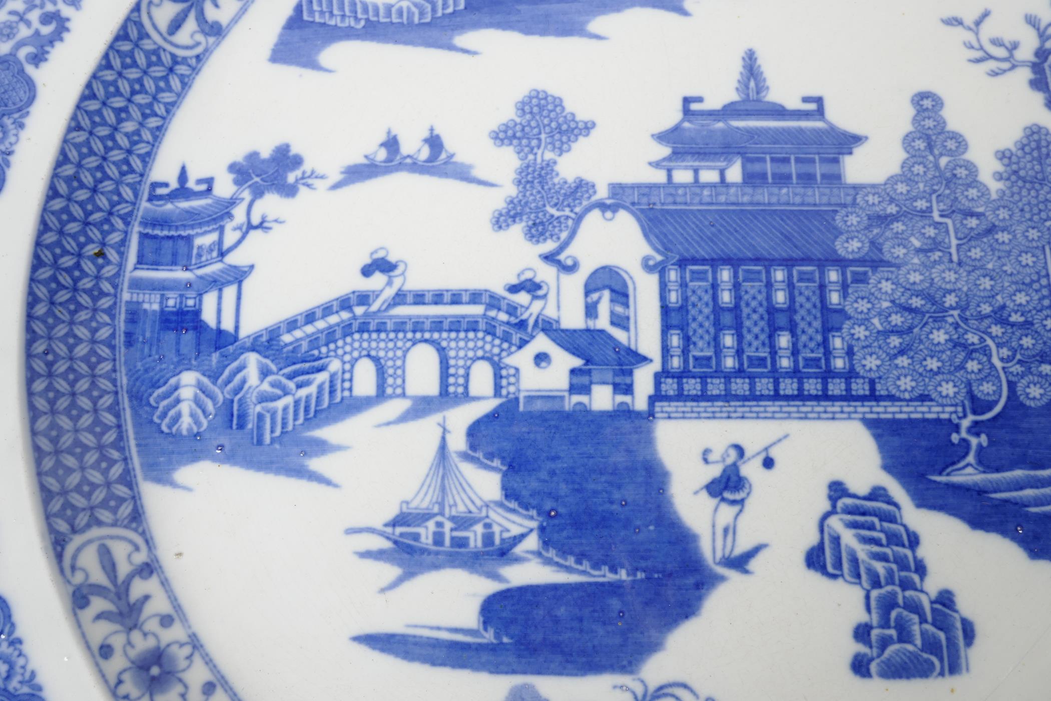 A Staffordshire blue and white charger decorated with the Long Bridge variation of the Willow - Image 2 of 3