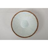 A Song style celadon glazed porcelain conical bowl with underglaze phoenix and floral decoration,