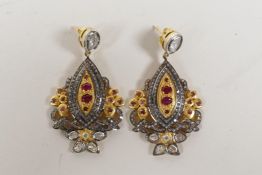 A pair of silver gilt drop earrings set with uncut diamonds and rubies, 2" drop