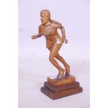 A carved wood figure of a female tennis player, A/F repairs, 12" high