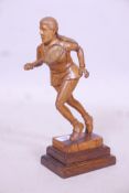A carved wood figure of a female tennis player, A/F repairs, 12" high