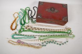 A quantity of glass and hardstone bead necklaces etc in a decorative box