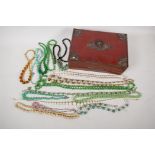 A quantity of glass and hardstone bead necklaces etc in a decorative box