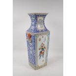 A polychrome porcelain vase with two lion mask handles, two decorative panels depicting immortals,