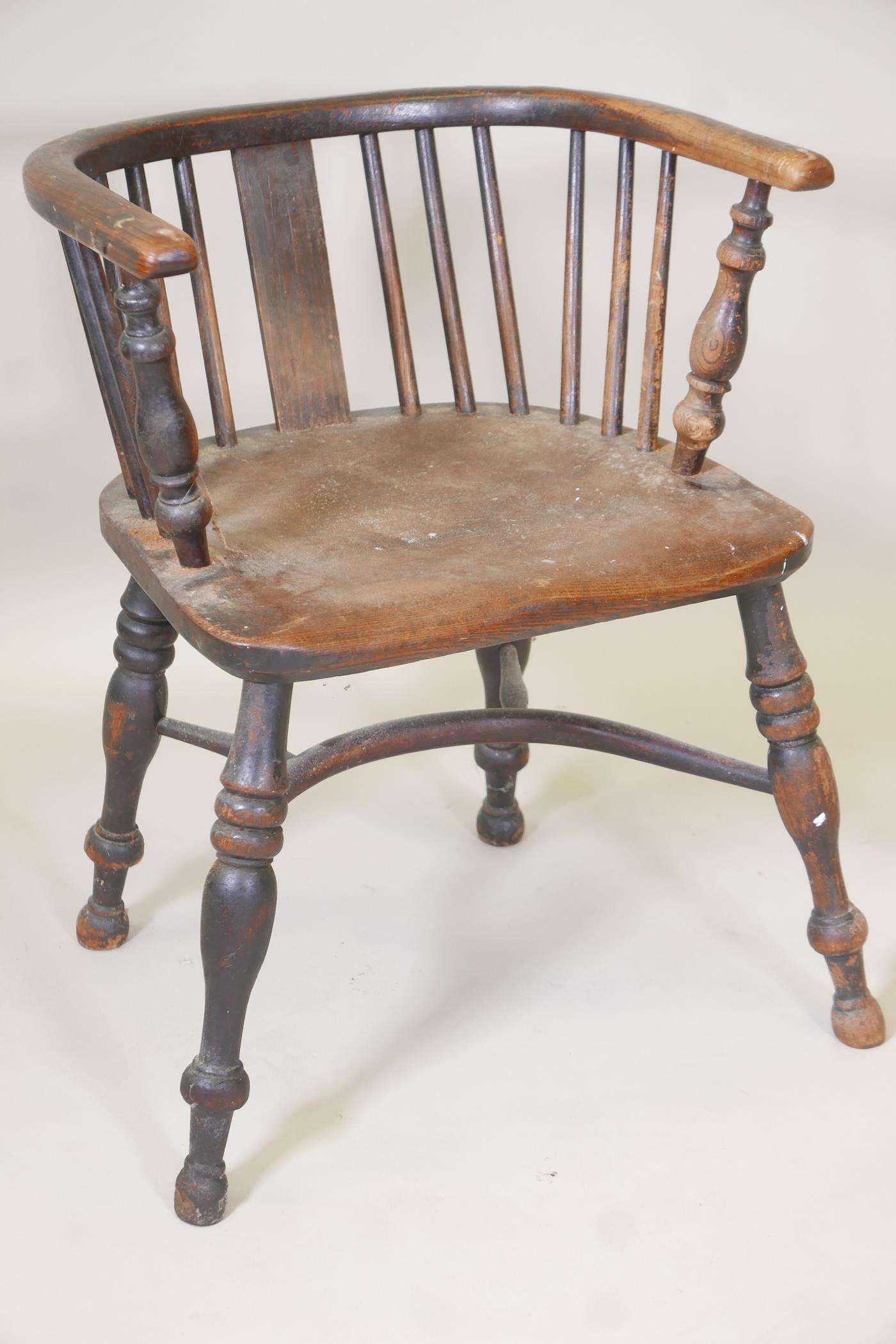 A C19th ash and elm seated bow arm chair, with crinoline stretcher and turned supports (originally a