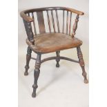 A C19th ash and elm seated bow arm chair, with crinoline stretcher and turned supports (originally a