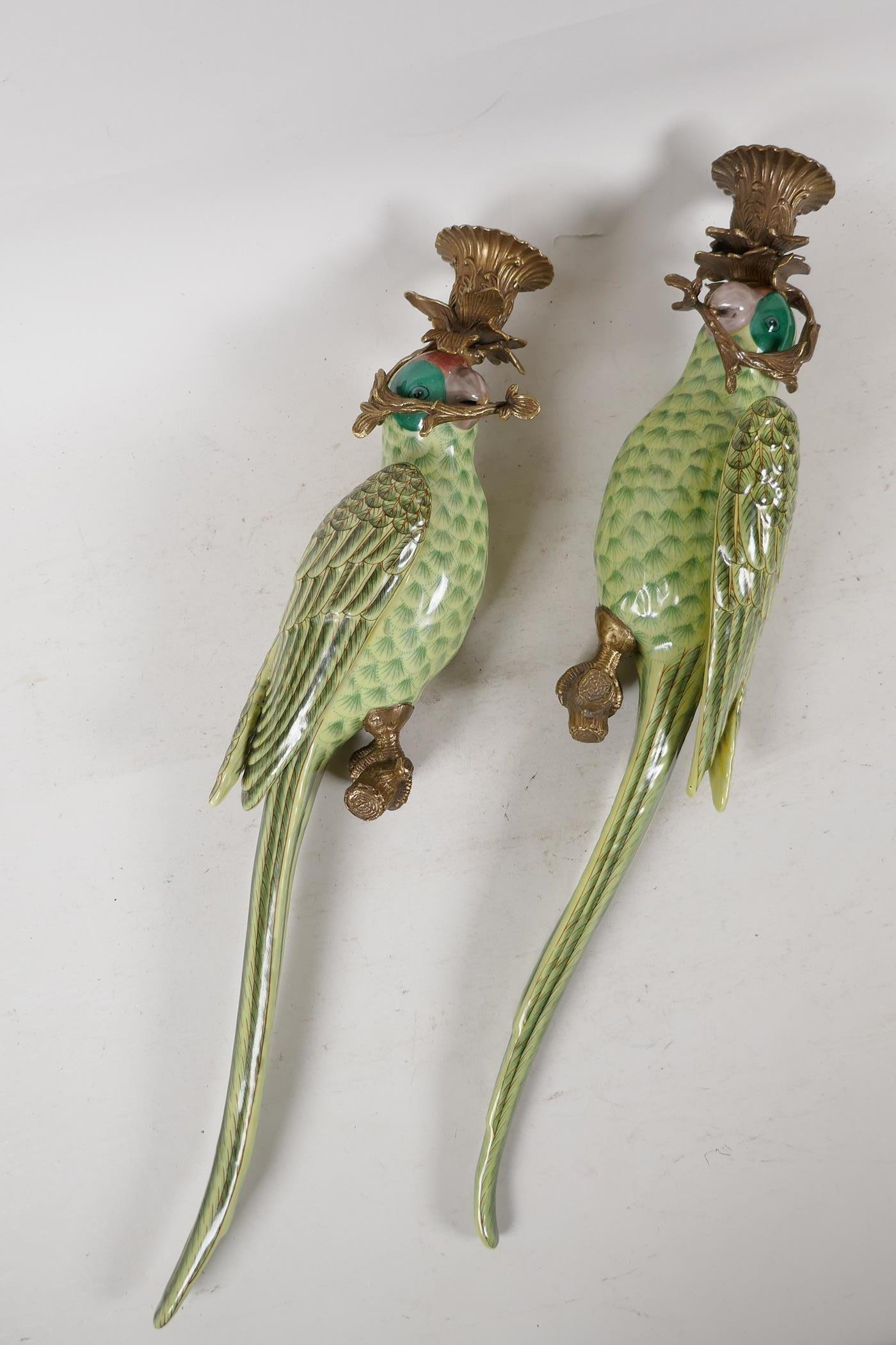 A pair of enamelled porcelain parakeet wall sconces with gilt metal mounts, 18½" long