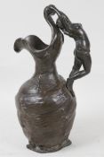 A French Art Nouveau pewter jug of organic form, the handle cast as a semi clad woman, 10" high
