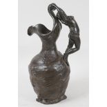 A French Art Nouveau pewter jug of organic form, the handle cast as a semi clad woman, 10" high