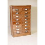 A 1920s walnut flight of sixteen drawers, arranged in two banks of eight, 27½" x 16", 44" high