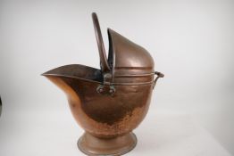 A helmet shaped copper coal scuttle, 21" high