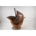 A helmet shaped copper coal scuttle, 21" high